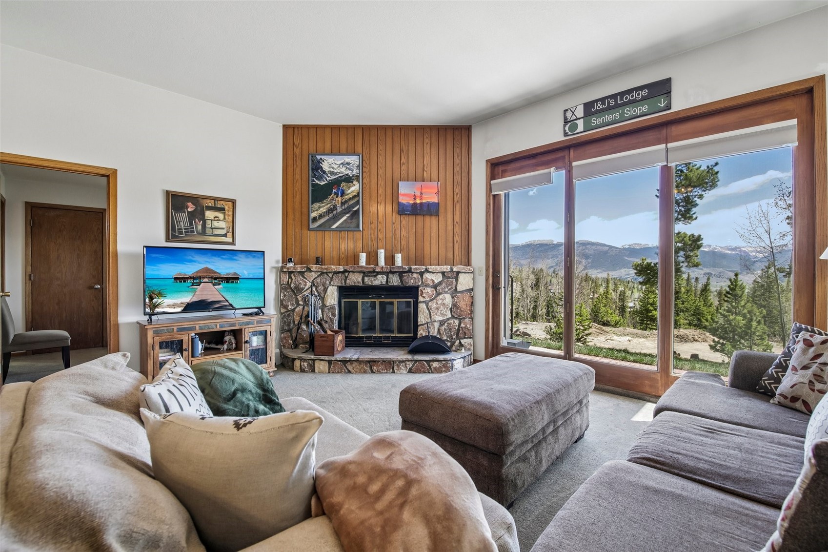 89310 Ryan Gulch Road, Unit 103 Silverthorne, CO 80498 - Photo 1 of 48 a living room with furniture large window and a flat screen tv