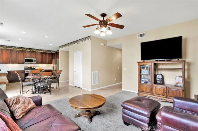a dining room with furniture and a large window