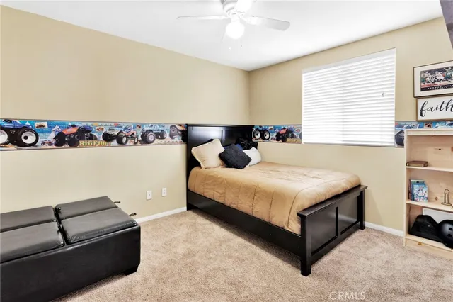 a bedroom with a bed a dresser and a window