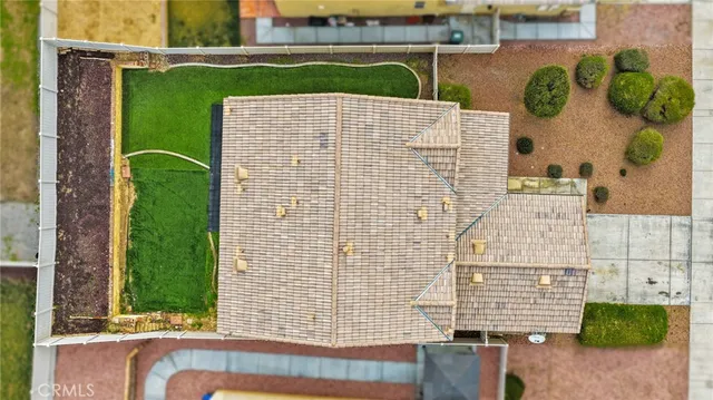 an aerial view of a house with a yard