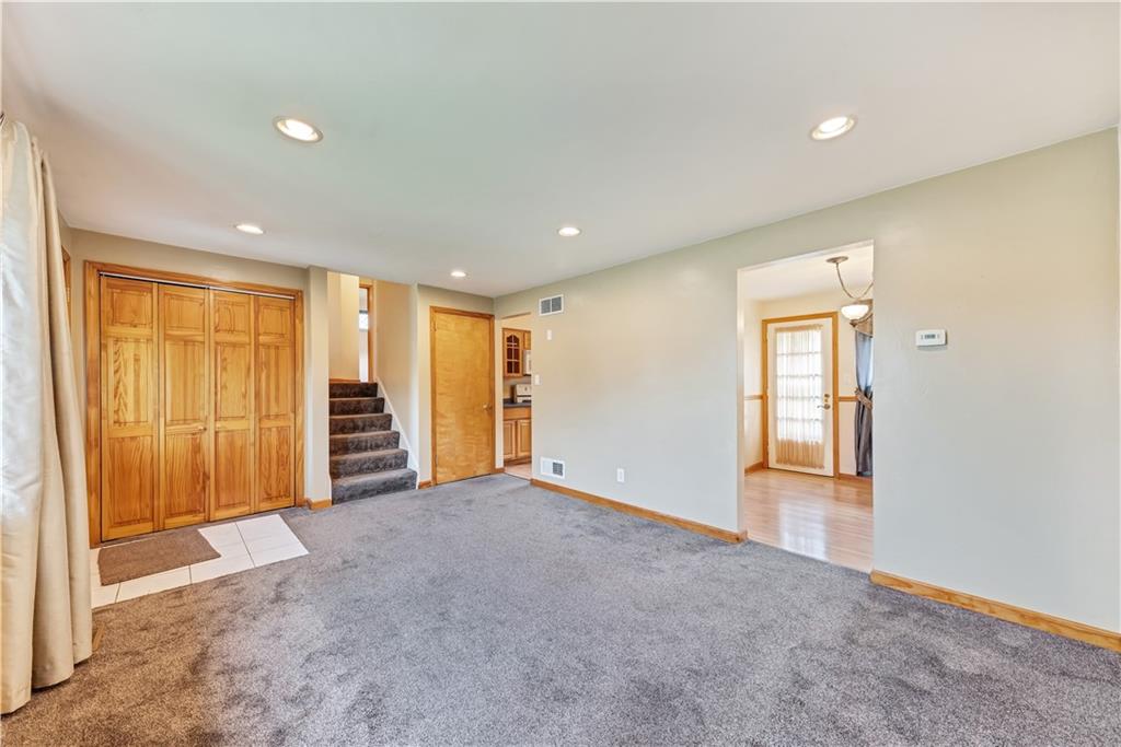 98 Grace Street McKees Rocks, PA 15136 - Photo 3 of 15 a view of an empty room with wooden floor and windows