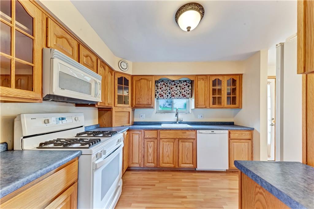 98 Grace Street McKees Rocks, PA 15136 - Photo 4 of 15 a kitchen with stainless steel appliances granite countertop a stove and a sink