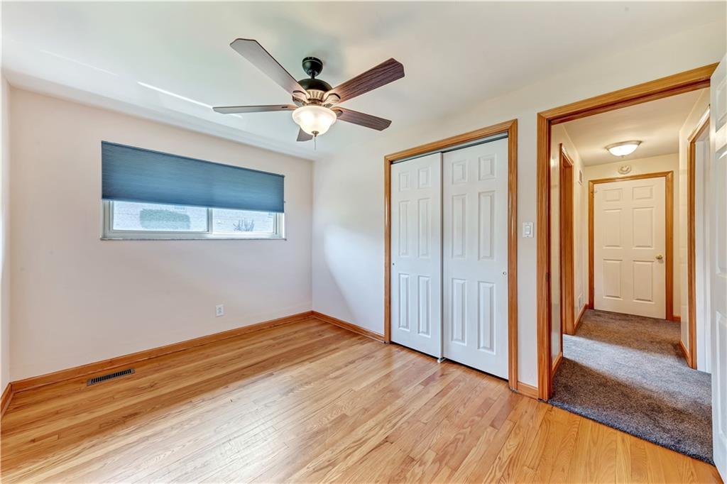 98 Grace Street McKees Rocks, PA 15136 - Photo 7 of 15 a view of empty room with wooden floor and fan