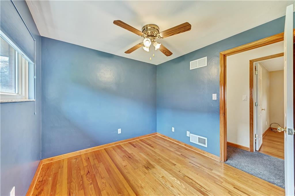 98 Grace Street McKees Rocks, PA 15136 - Photo 8 of 15 a view of a room with a ceiling fan and wooden floor