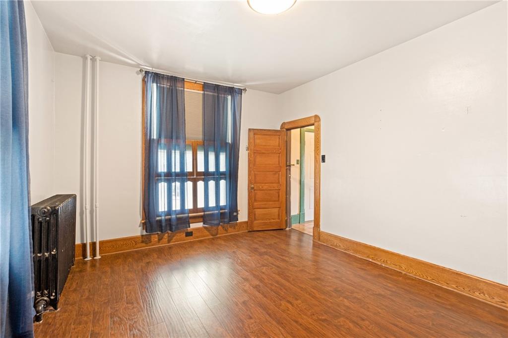 308 East Main Street Stoystown, PA 15563 - Photo 12 of 49 an empty room with wooden floor and windows