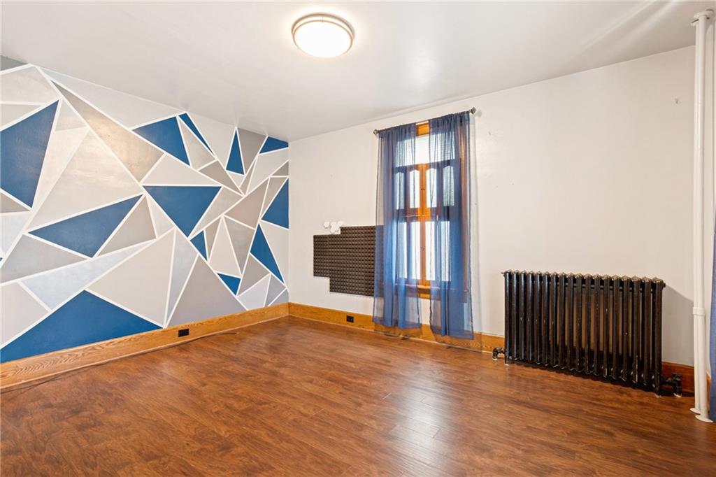 308 East Main Street Stoystown, PA 15563 - Photo 13 of 49 a view of an empty room with wooden floor and a ceiling fan