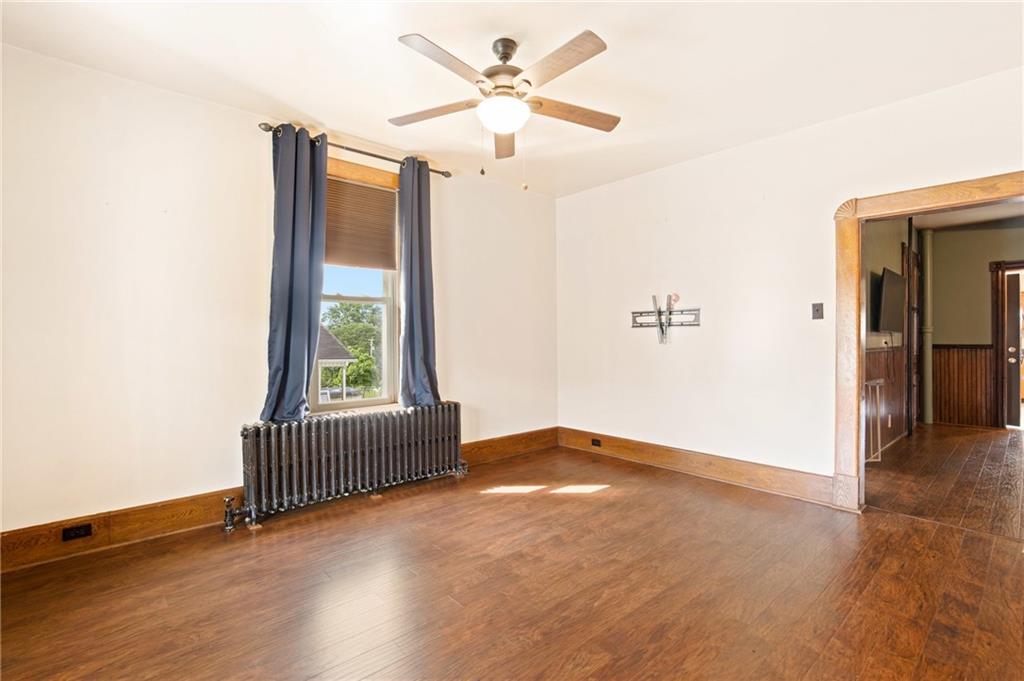 308 East Main Street Stoystown, PA 15563 - Photo 15 of 49 an empty room with wooden floor fan and windows