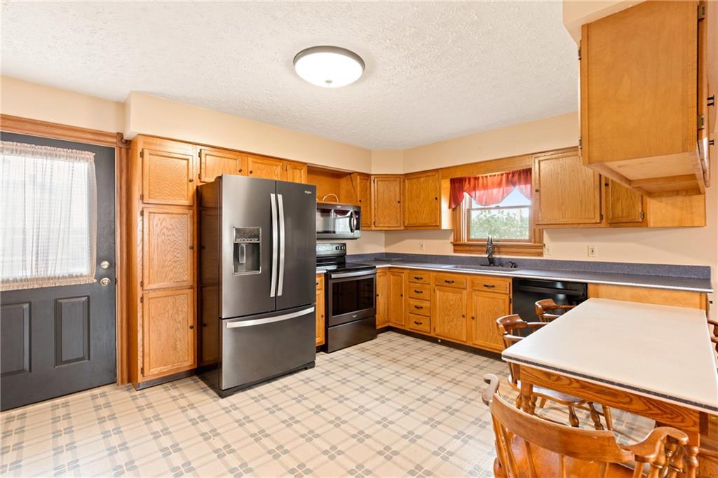 308 East Main Street Stoystown, PA 15563 - Photo 22 of 49 a kitchen with stainless steel appliances granite countertop a refrigerator and a sink