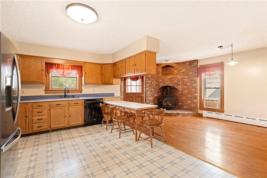 308 East Main Street Stoystown, PA 15563 - Photo 23 of 49 a open kitchen with stainless steel appliances granite countertop a stove top oven a sink dishwasher and cabinets with wooden floor