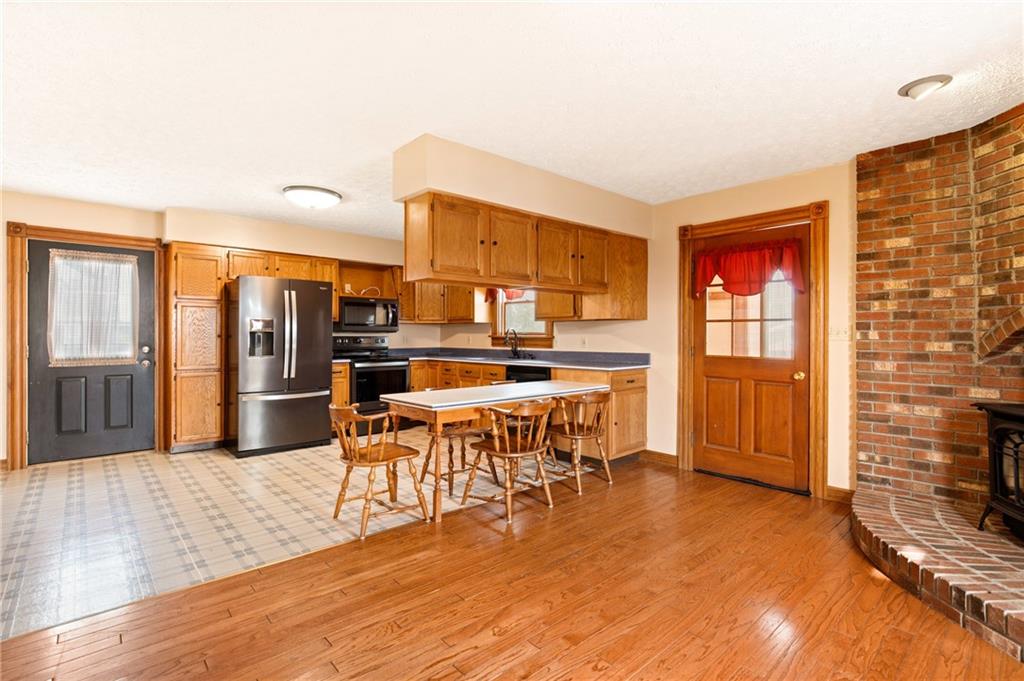 308 East Main Street Stoystown, PA 15563 - Photo 25 of 49 a dining hall with stainless steel appliances a dining table and chairs with wooden floor