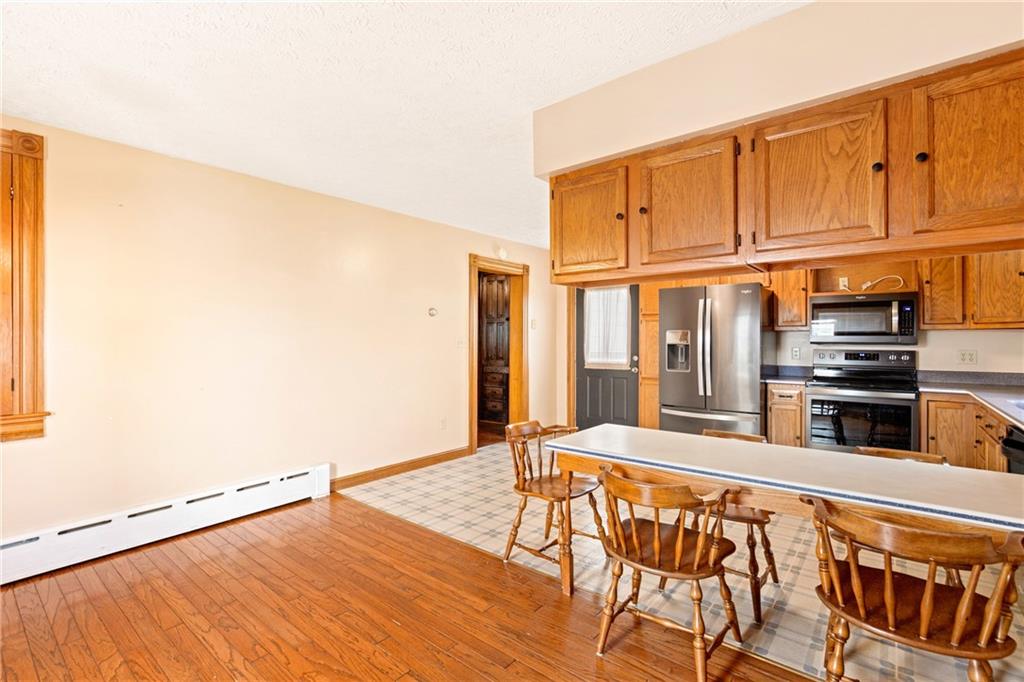308 East Main Street Stoystown, PA 15563 - Photo 26 of 49 a kitchen with granite countertop a stove and cabinets