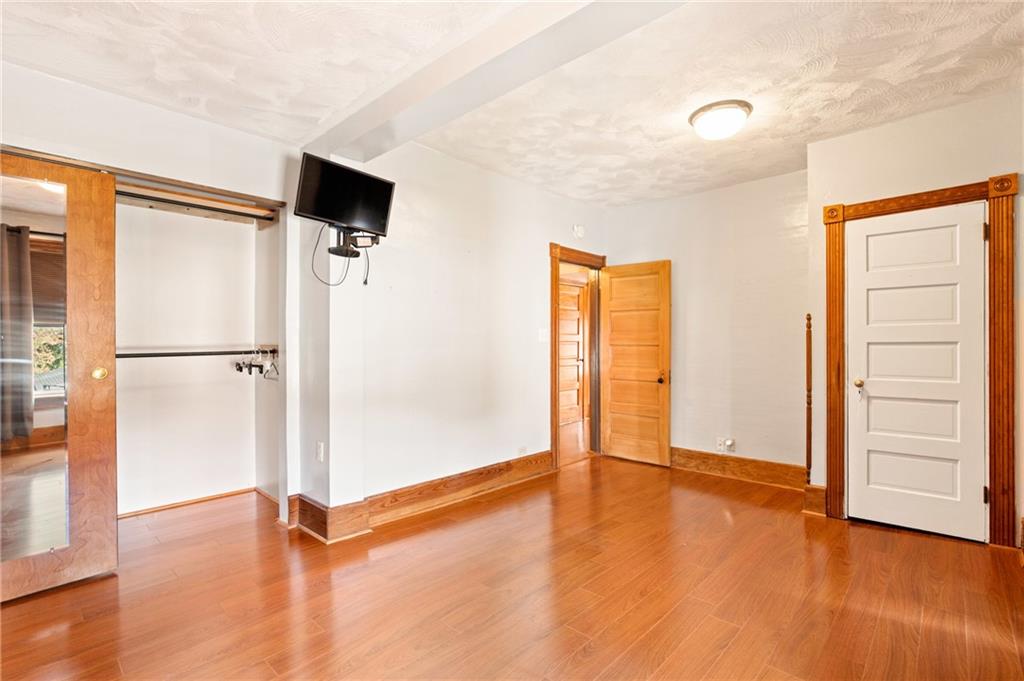 308 East Main Street Stoystown, PA 15563 - Photo 35 of 49 a view of an empty room with wooden floor and a window