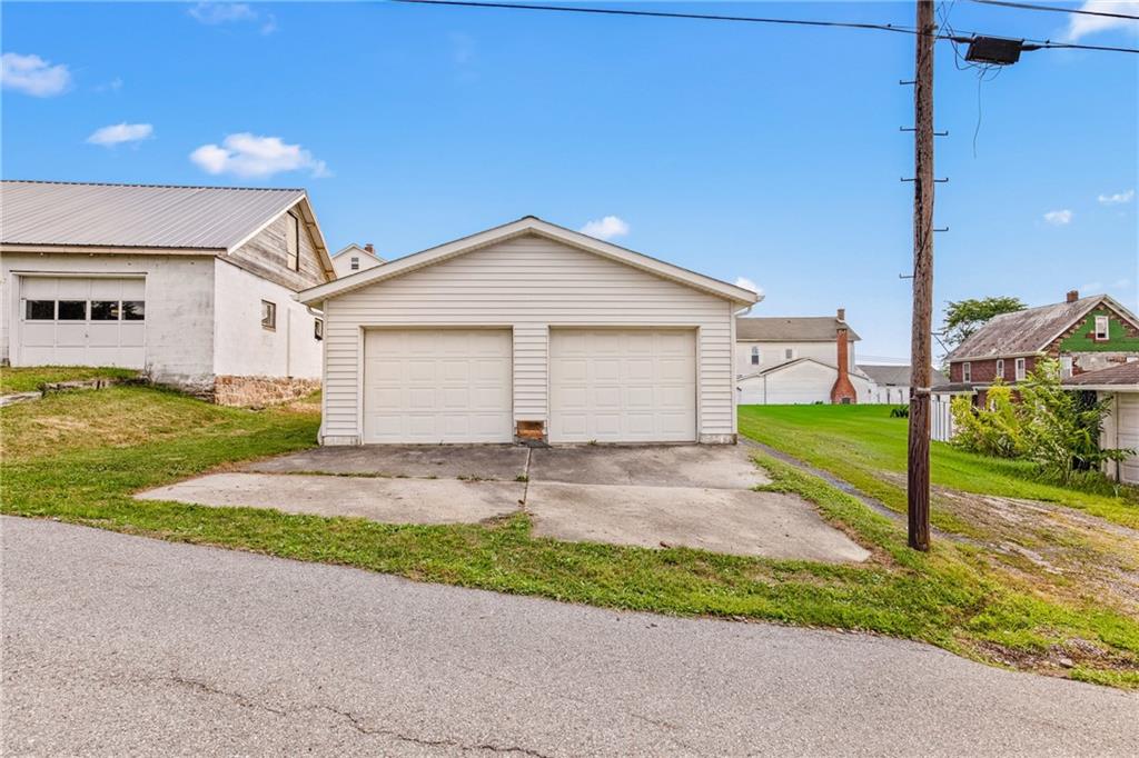 308 East Main Street Stoystown, PA 15563 - Photo 38 of 49 a front view of a house with a yard and garage