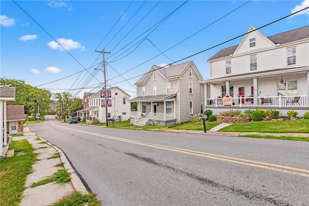 308 East Main Street Stoystown, PA 15563 - Photo 4 of 49 a front view of a house with a yard and porch