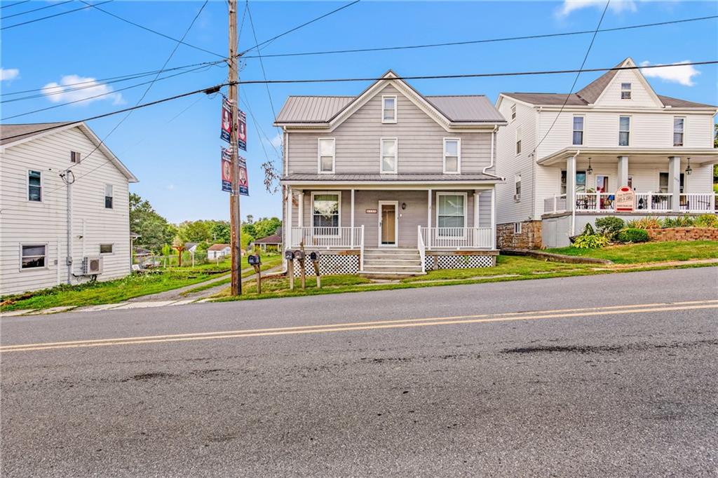 308 East Main Street Stoystown, PA 15563 - Photo 5 of 49 a front view of a house with a garden and plants