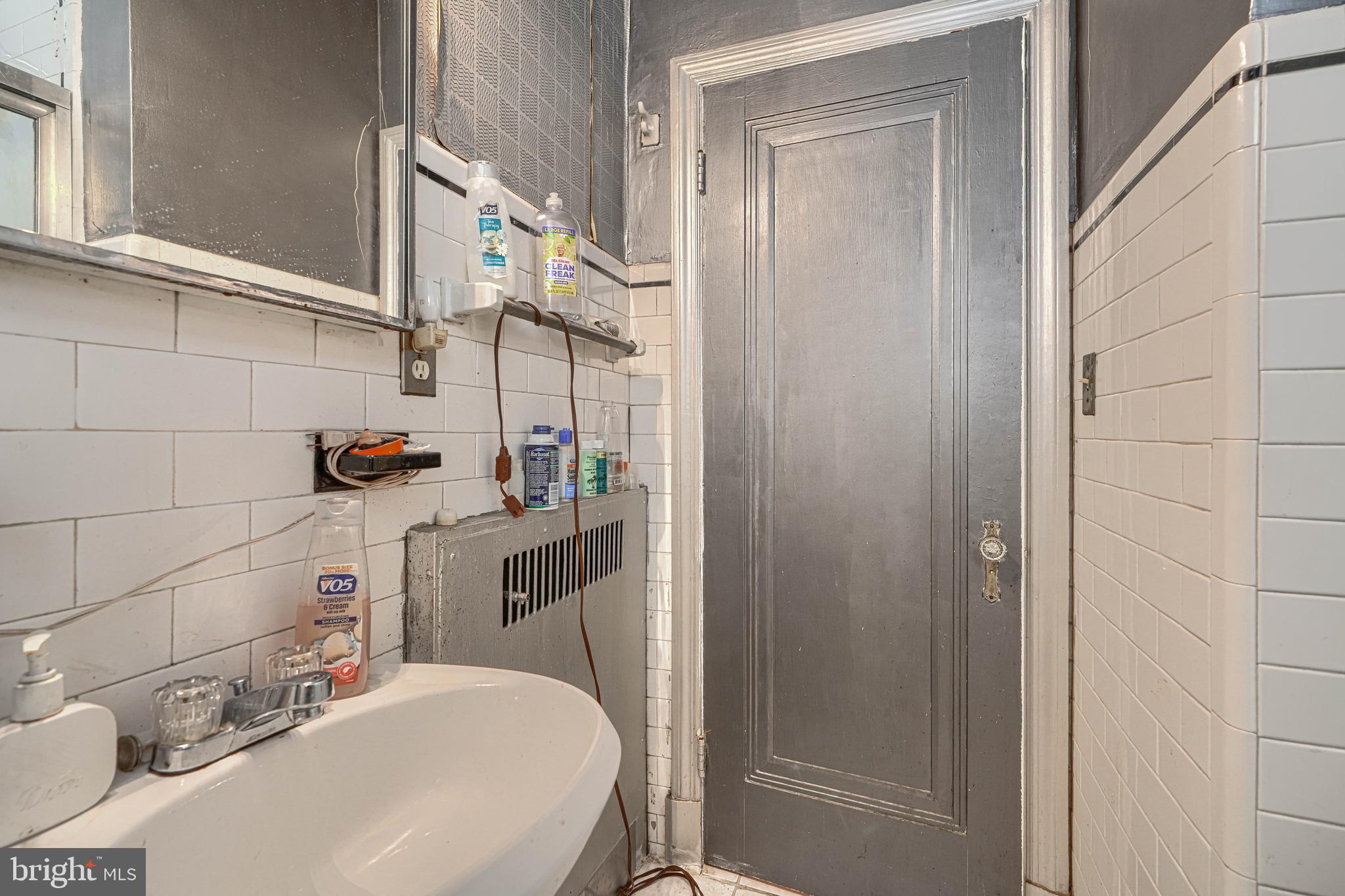 3212 Dorchester Road Baltimore, MD 21215 - Photo 34 of 45 a bathroom with a sink a toilet and shower