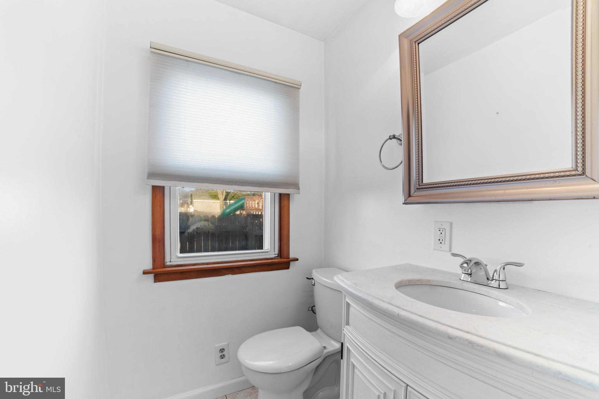 319 South Coles Avenue Maple Shade, NJ 08052 - Photo 12 of 23 a bathroom with a toilet a sink and mirror