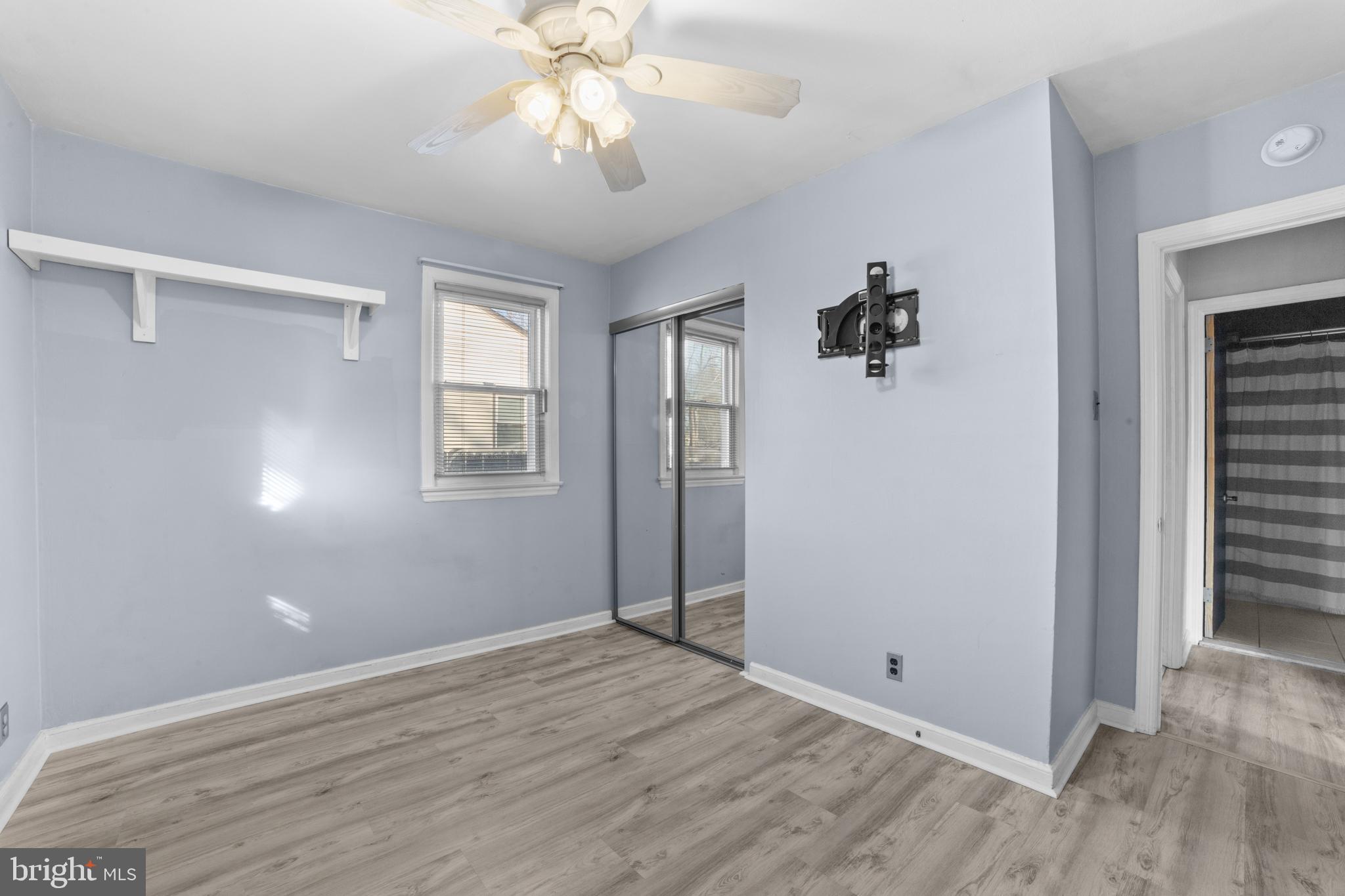 319 South Coles Avenue Maple Shade, NJ 08052 - Photo 19 of 23 an empty room with wooden floor chandelier fan and windows