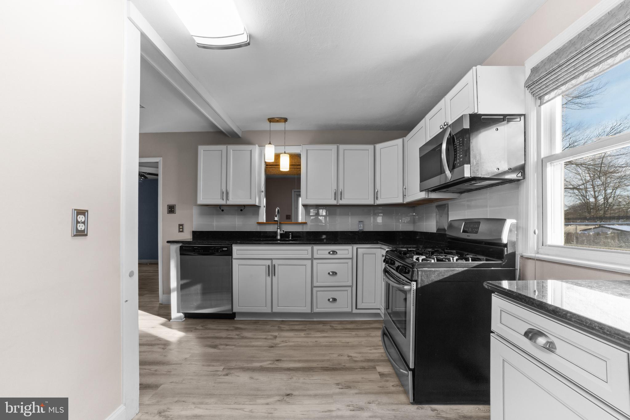 319 South Coles Avenue Maple Shade, NJ 08052 - Photo 6 of 23 a kitchen with stainless steel appliances granite countertop a stove a sink and a microwave