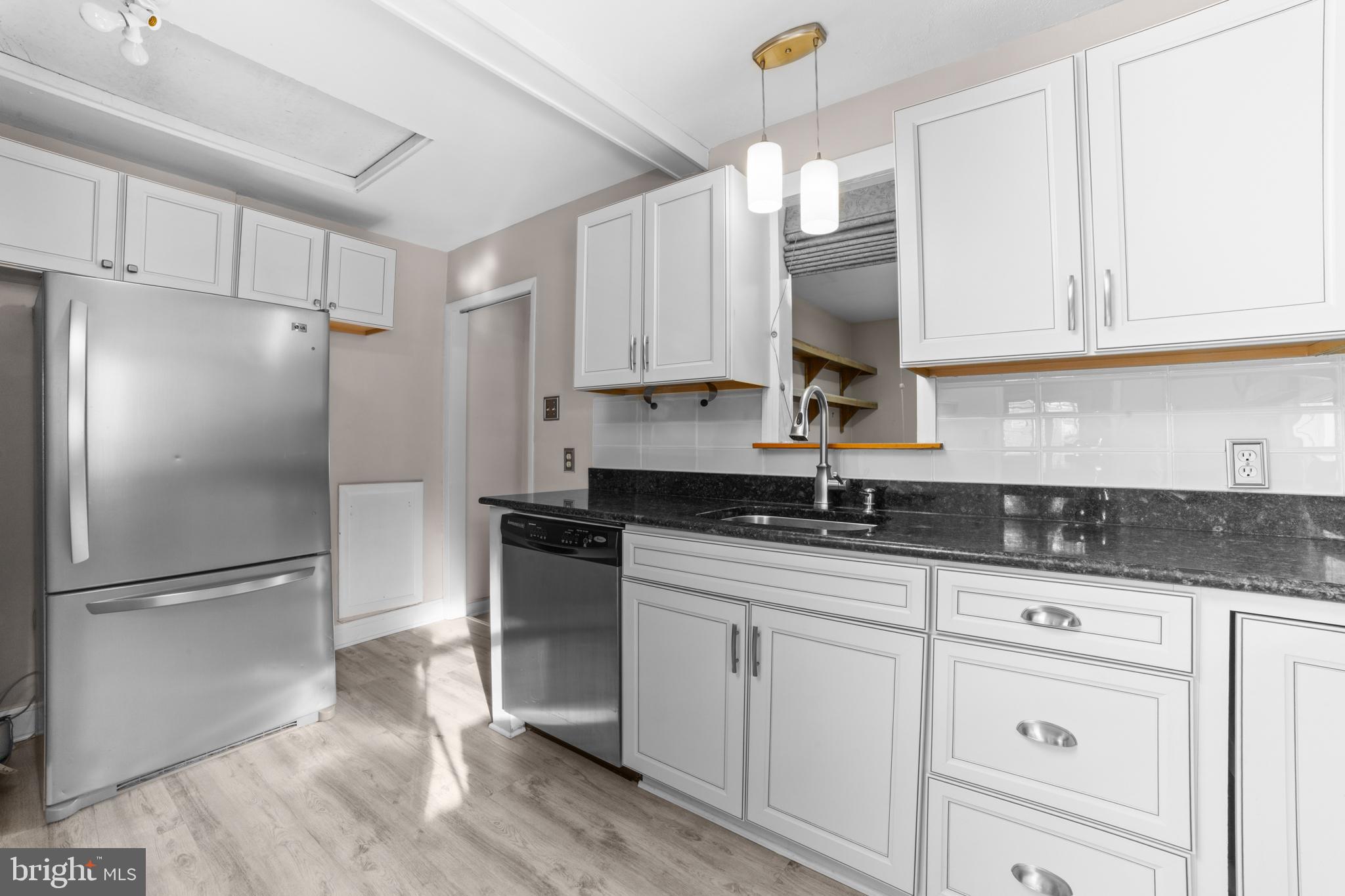 319 South Coles Avenue Maple Shade, NJ 08052 - Photo 7 of 23 a kitchen with granite countertop white cabinets and stainless steel appliances