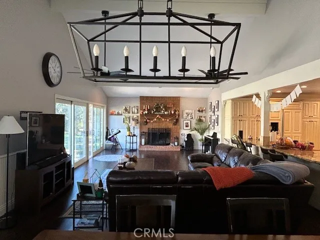 a living room with furniture a large window and a table