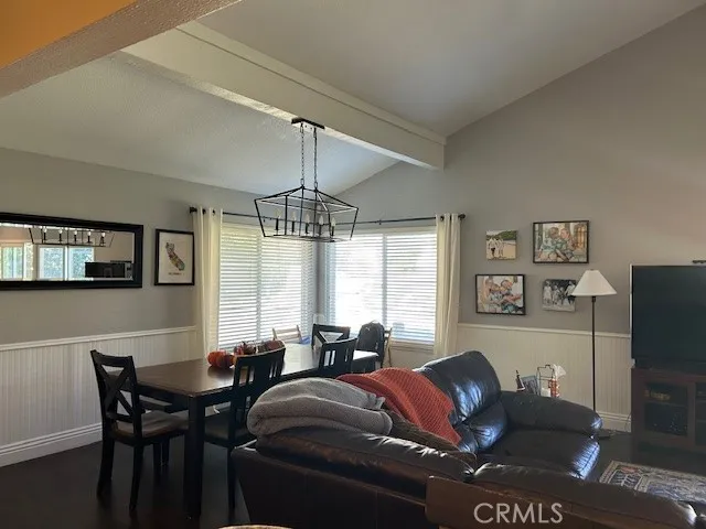 a living room with furniture a fireplace and a large window