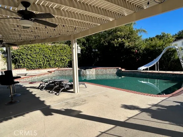 a view of a swimming pool with a patio