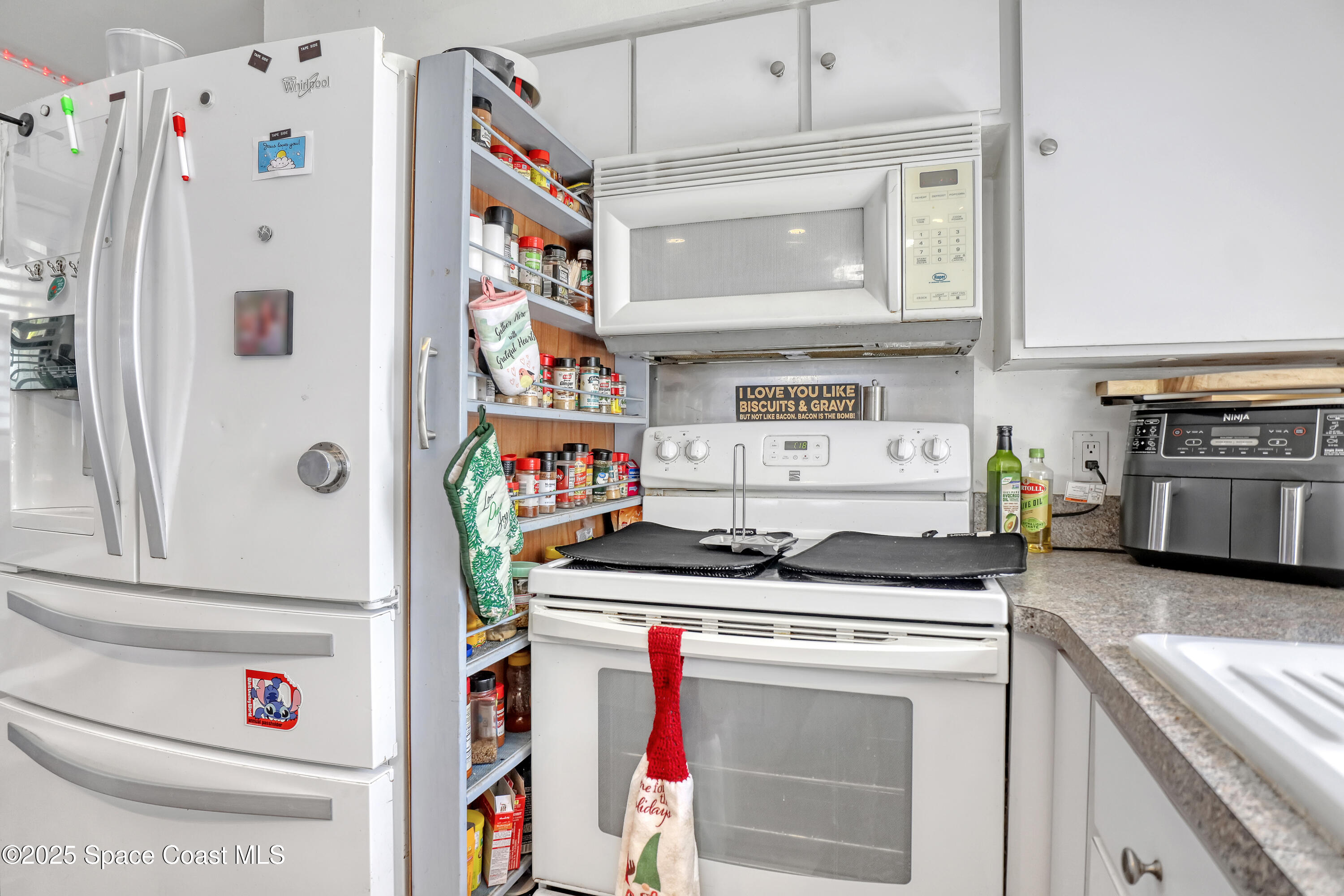 355 Aztec Avenue Merritt Island, FL 32952 - Photo 15 of 48 a kitchen with stainless steel appliances granite countertop a stove and a refrigerator