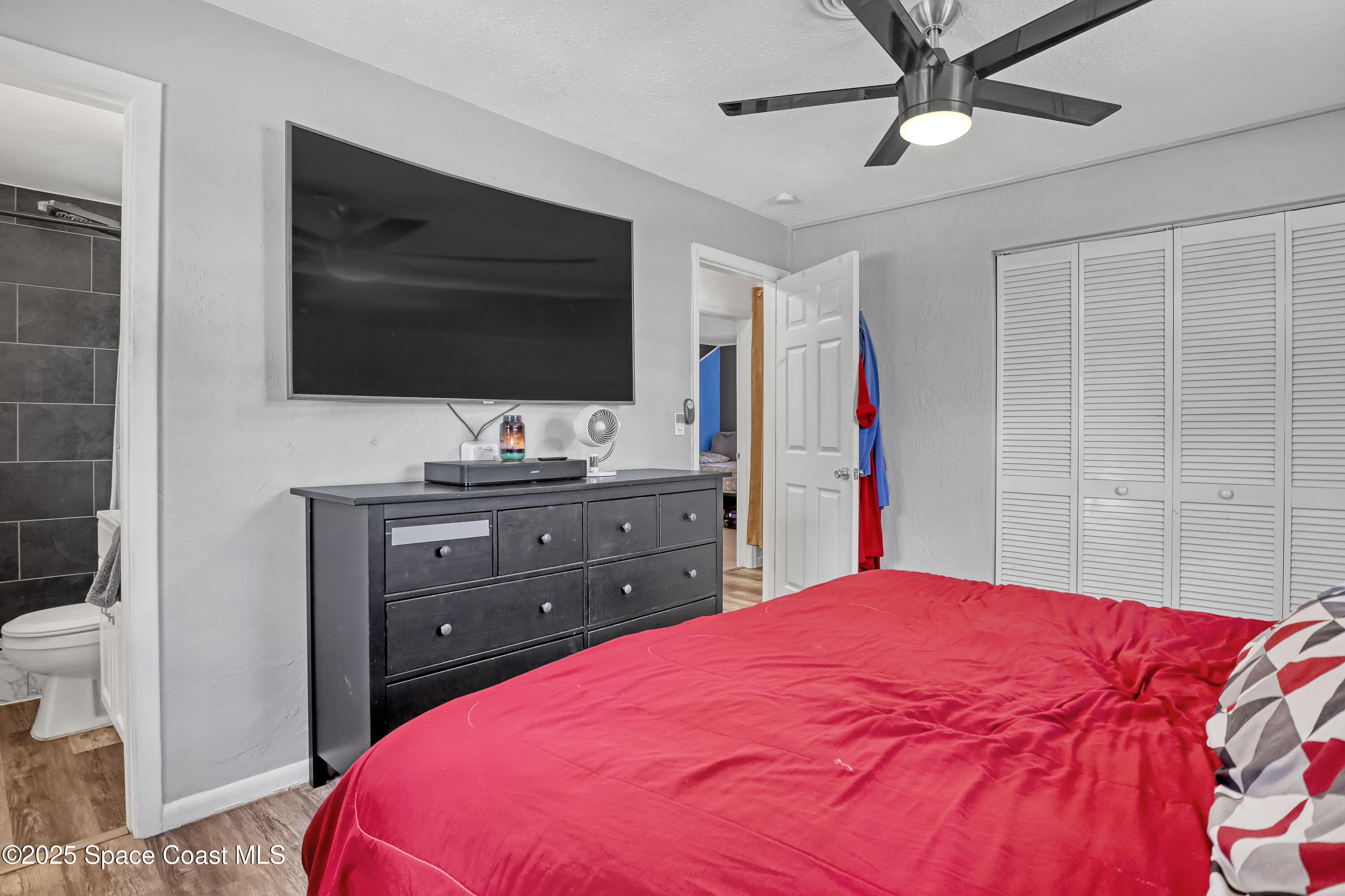 355 Aztec Avenue Merritt Island, FL 32952 - Photo 18 of 48 a bedroom with a bed and a flat screen tv