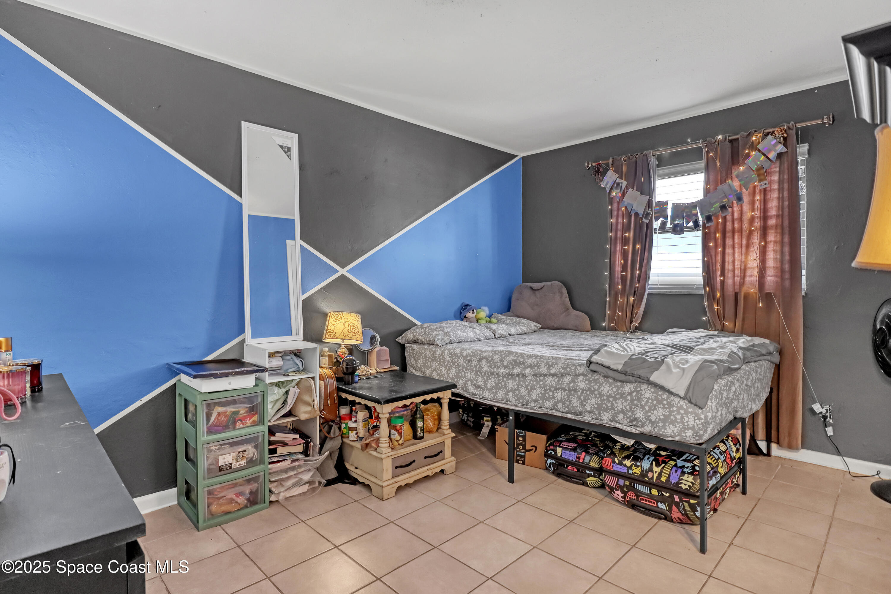 355 Aztec Avenue Merritt Island, FL 32952 - Photo 22 of 48 a bedroom with furniture and natural light