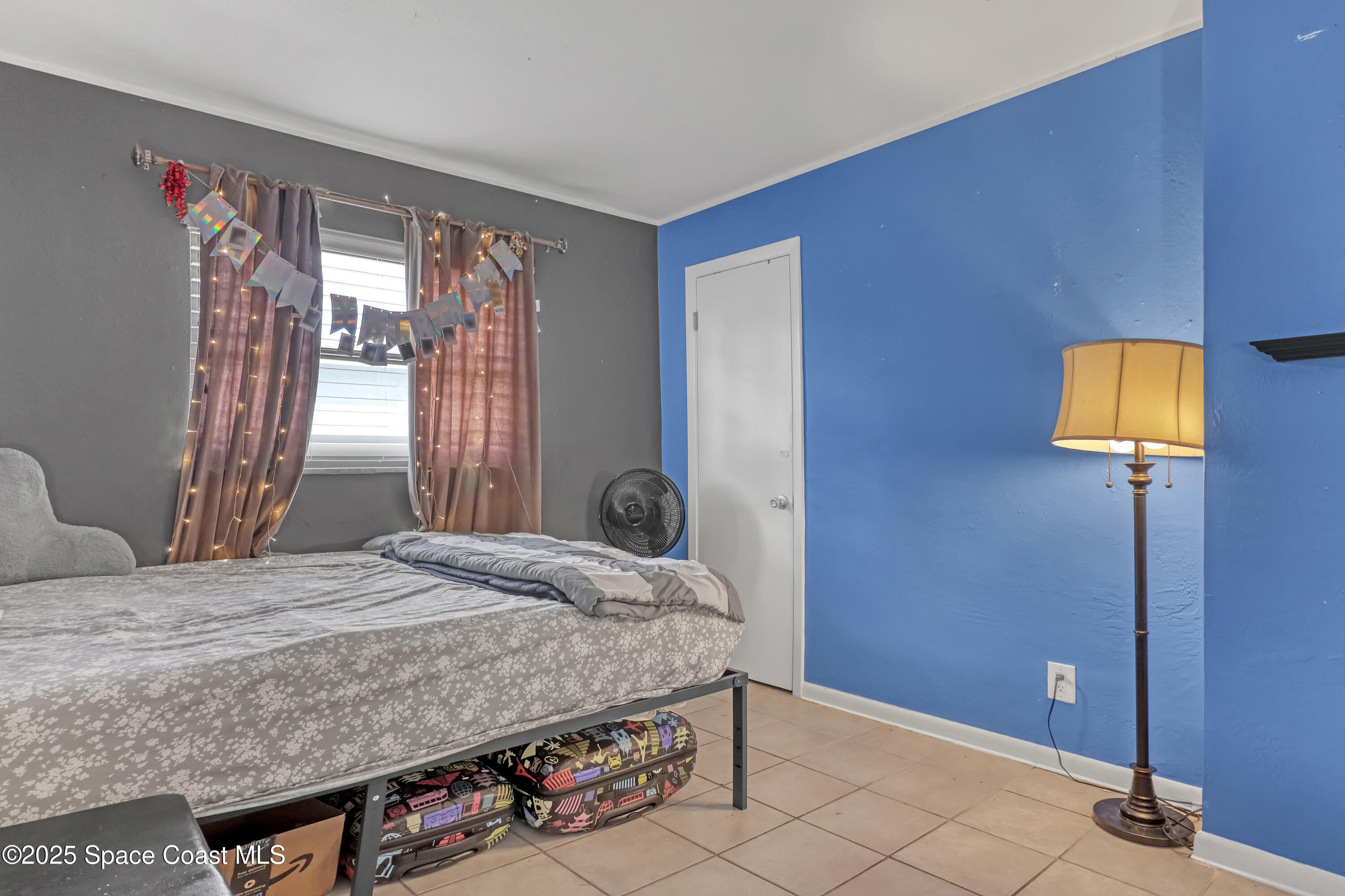 355 Aztec Avenue Merritt Island, FL 32952 - Photo 23 of 48 a bedroom with a bed and a window