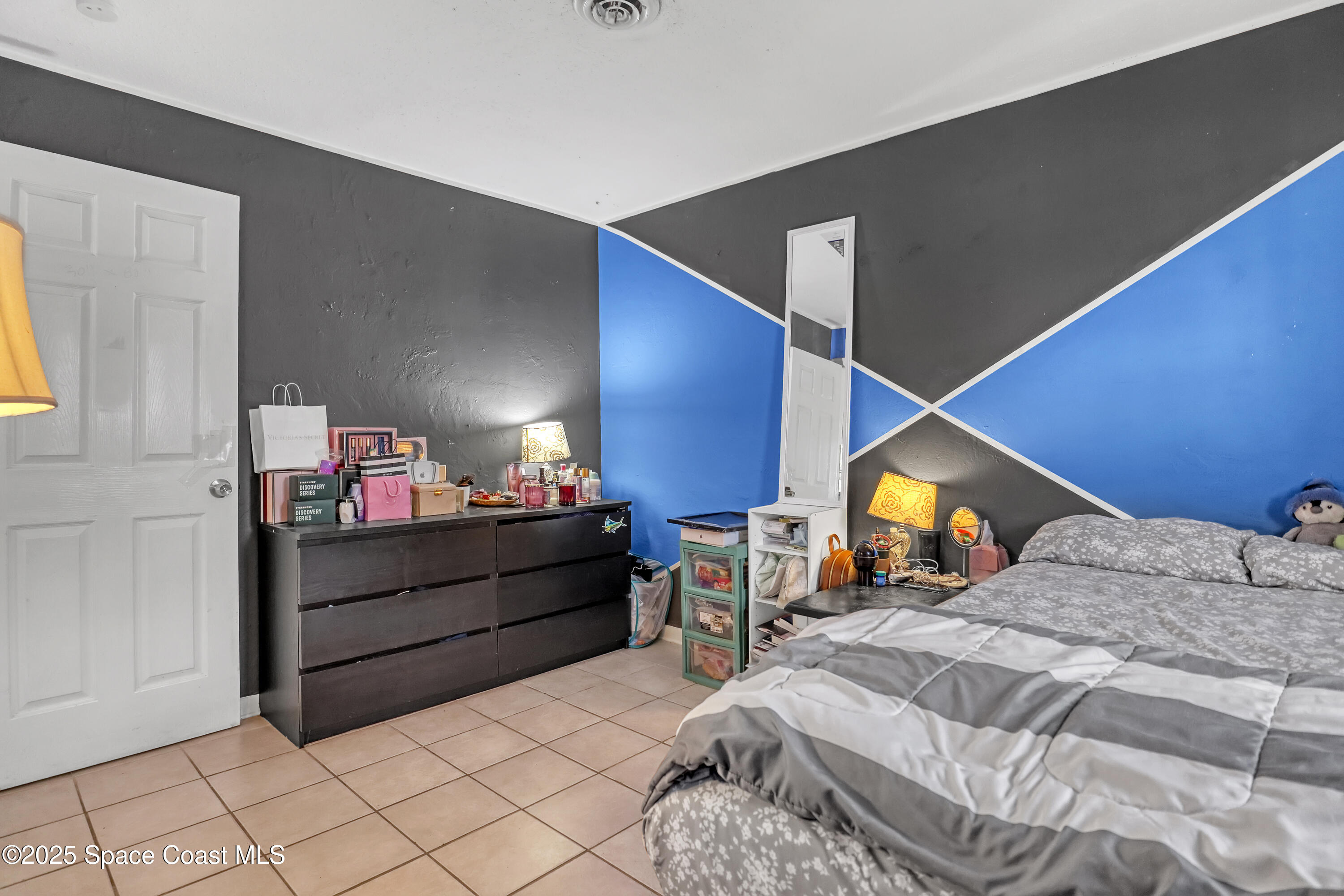 355 Aztec Avenue Merritt Island, FL 32952 - Photo 24 of 48 a bed room with a bed and a television