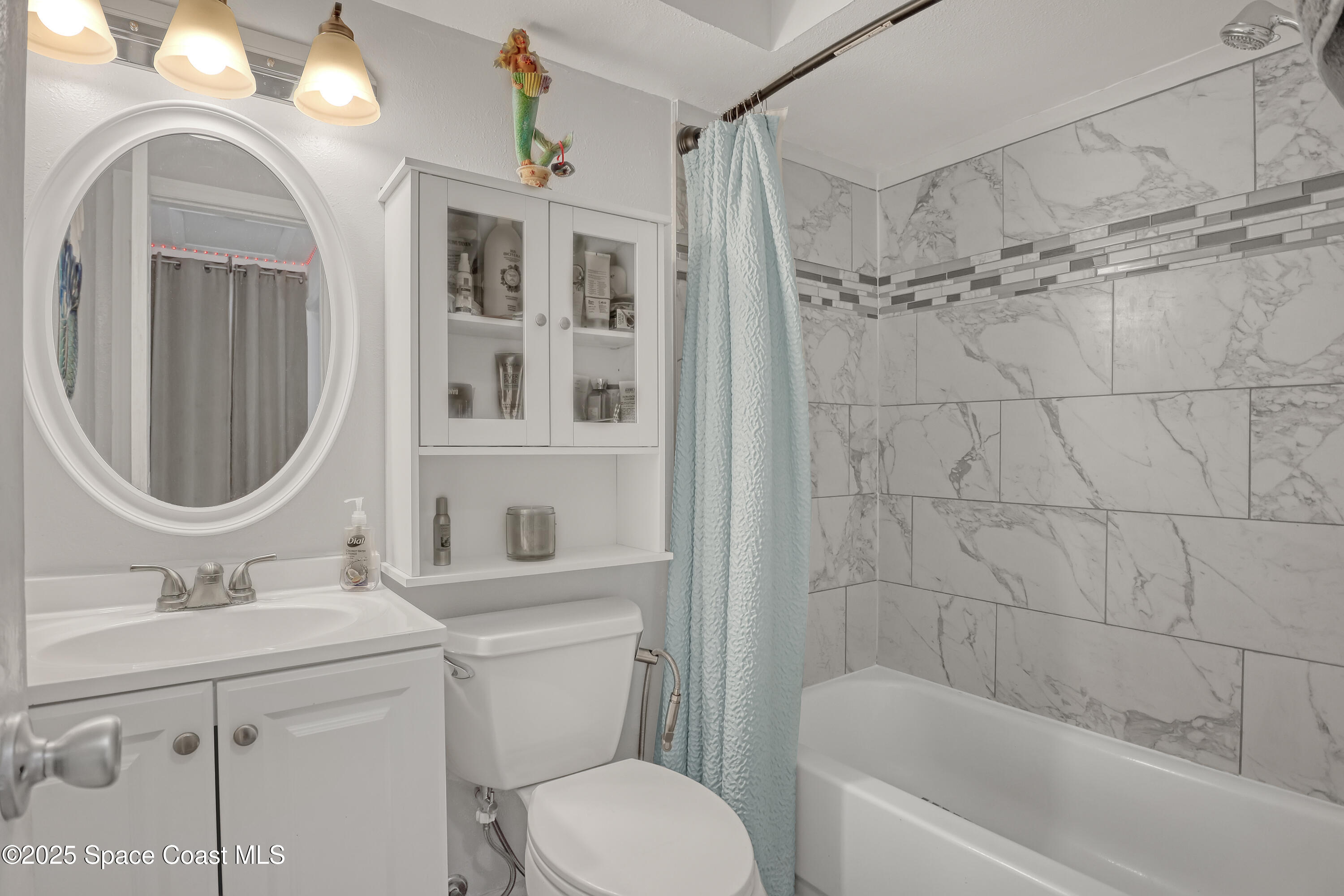 355 Aztec Avenue Merritt Island, FL 32952 - Photo 25 of 48 a bathroom with a sink a toilet and a mirror