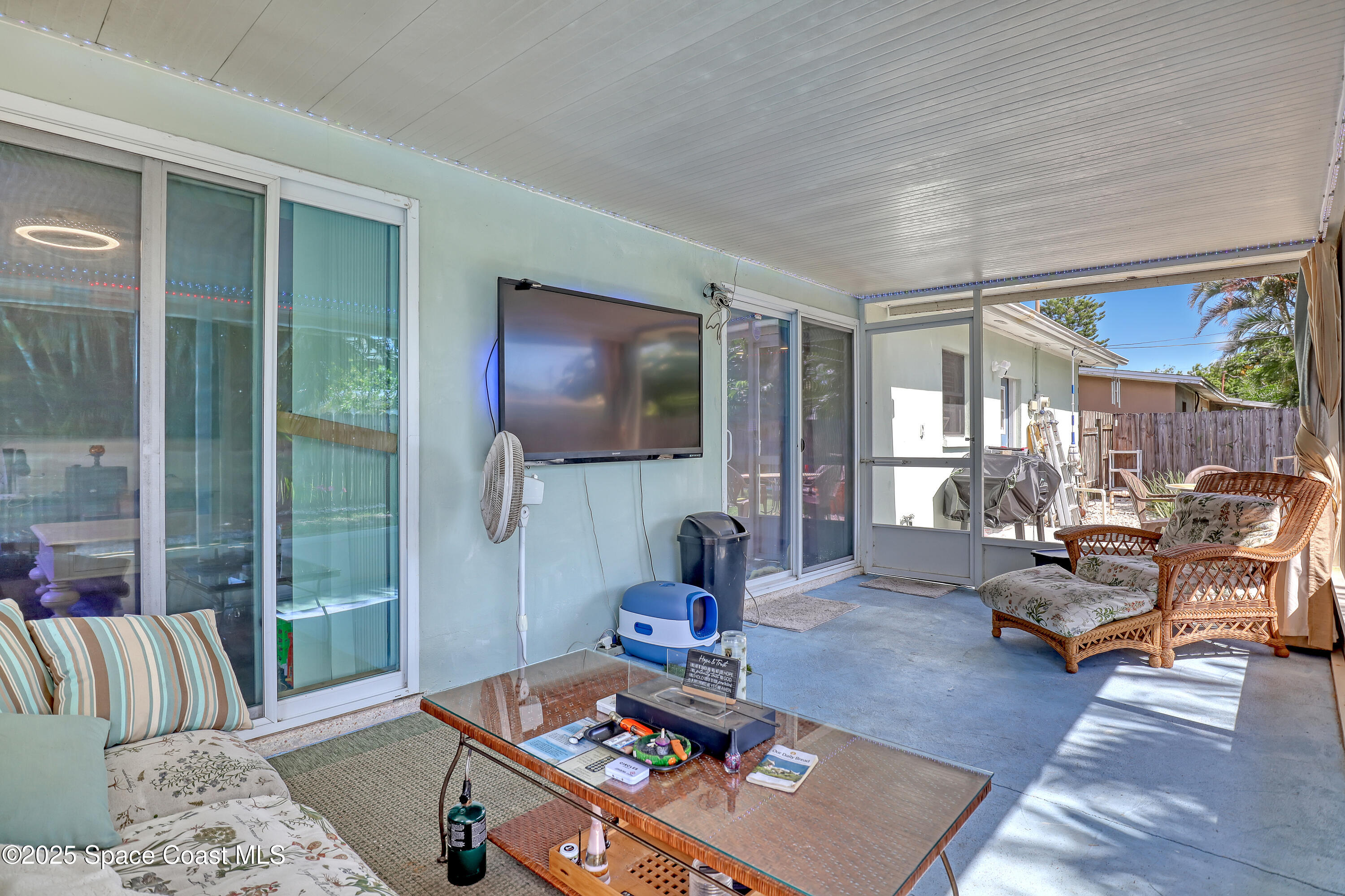 355 Aztec Avenue Merritt Island, FL 32952 - Photo 29 of 48 a living room with furniture and a flat screen tv
