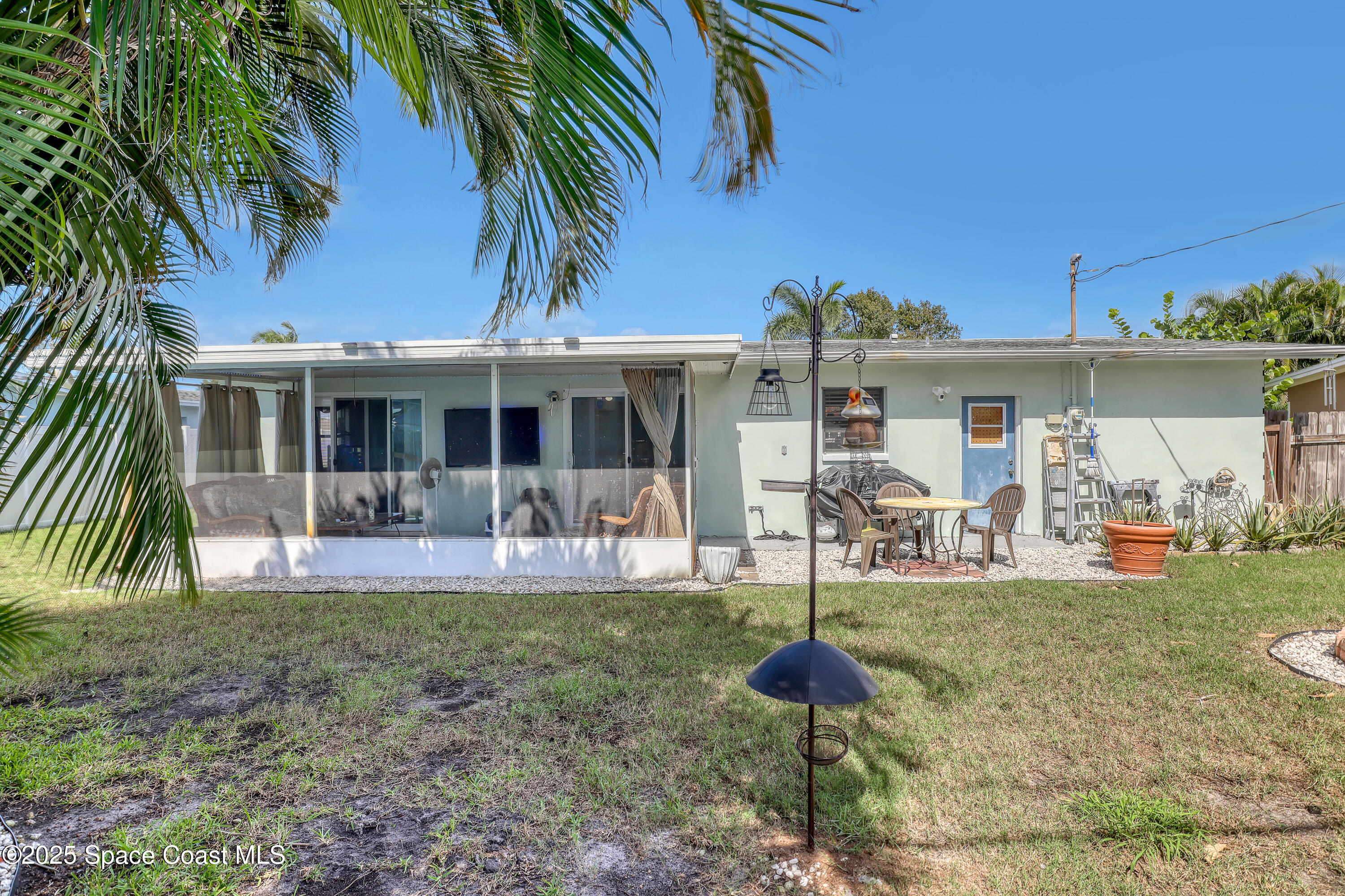 355 Aztec Avenue Merritt Island, FL 32952 - Photo 31 of 48 a front view of a house with garden and sitting area