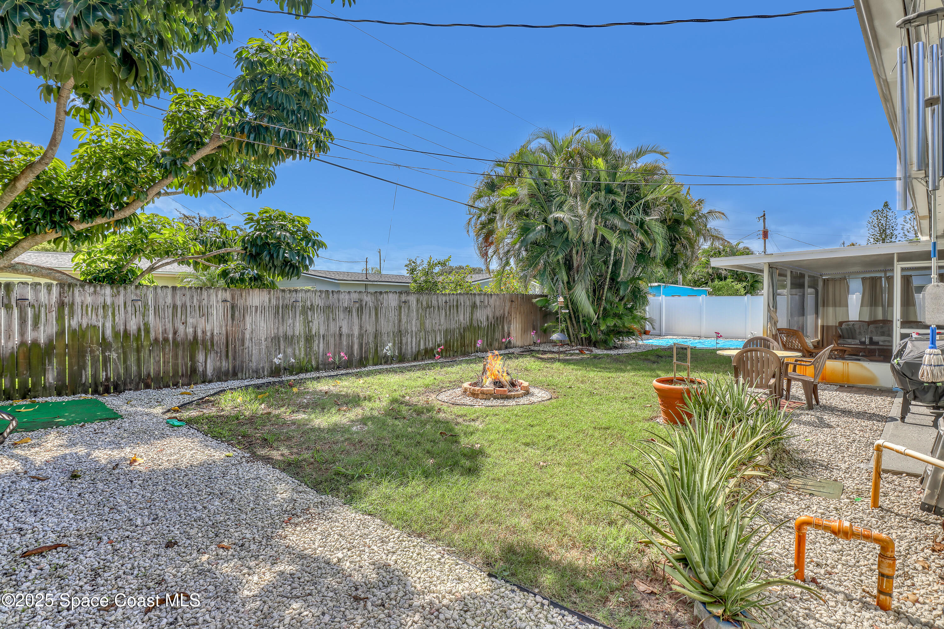 355 Aztec Avenue Merritt Island, FL 32952 - Photo 33 of 48 a view of a backyard with couches plants and large tree