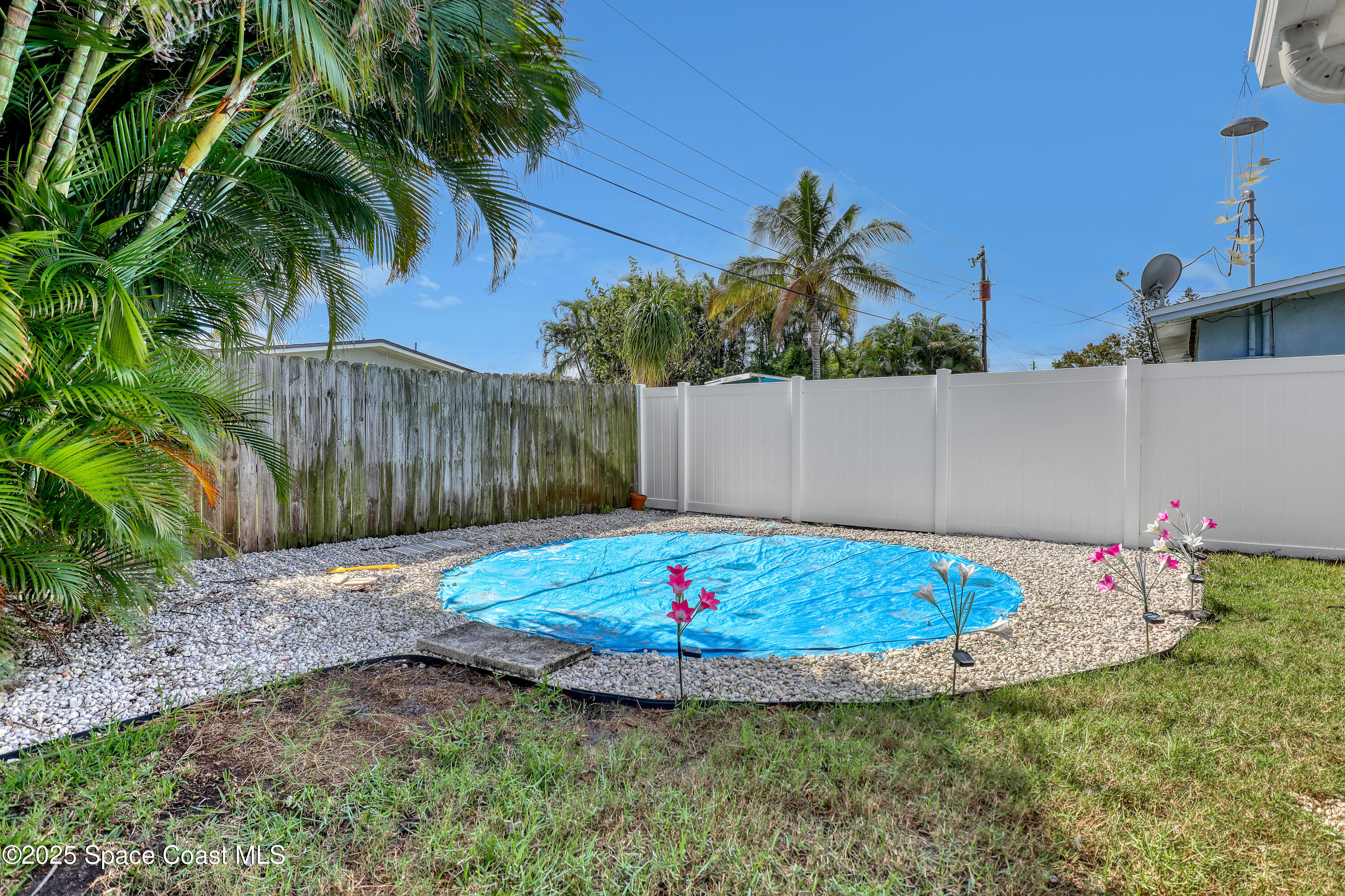 355 Aztec Avenue Merritt Island, FL 32952 - Photo 36 of 48 a view of a swimming pool with a yard