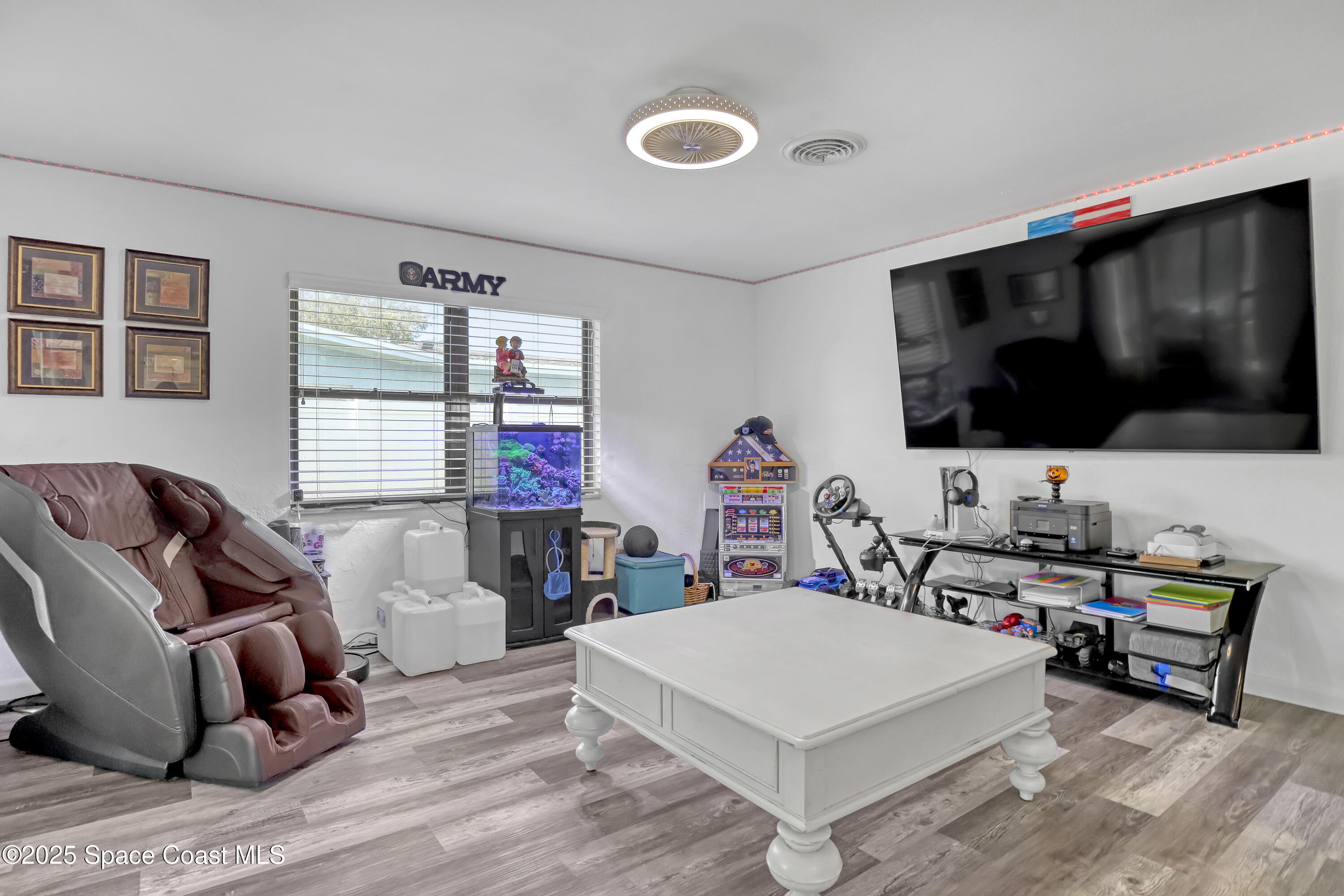 355 Aztec Avenue Merritt Island, FL 32952 - Photo 10 of 48 a living room with furniture and a flat screen tv