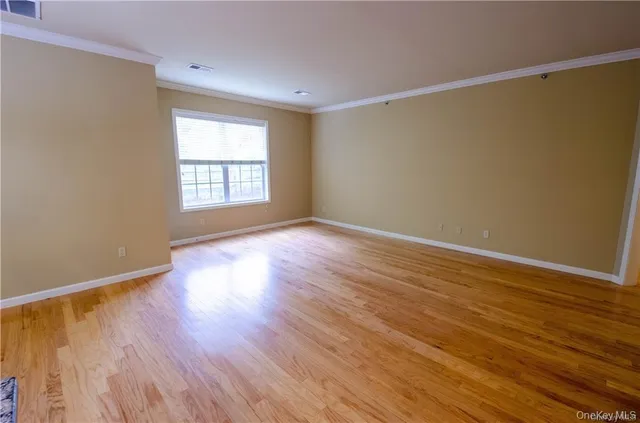 a view of a room with wooden floor and chandelier