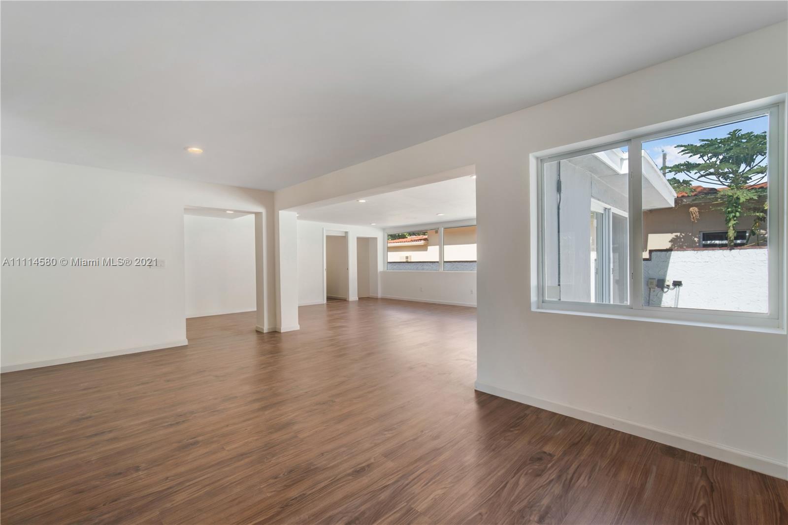 825 Southwest 28th Road Miami, FL 33129 - Photo 11 of 40 a view of empty room with wooden floor and fan