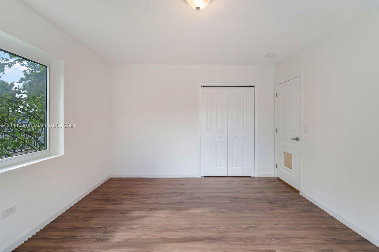 825 Southwest 28th Road Miami, FL 33129 - Photo 19 of 40 a view of room with hardwood floor and window