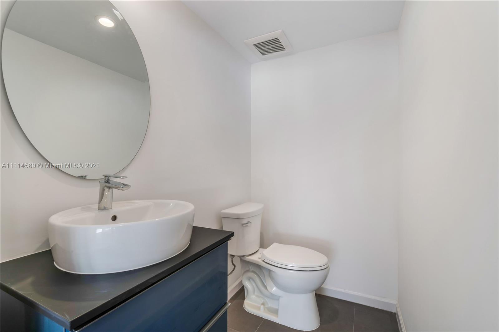 825 Southwest 28th Road Miami, FL 33129 - Photo 20 of 40 a bathroom with a sink and a mirror