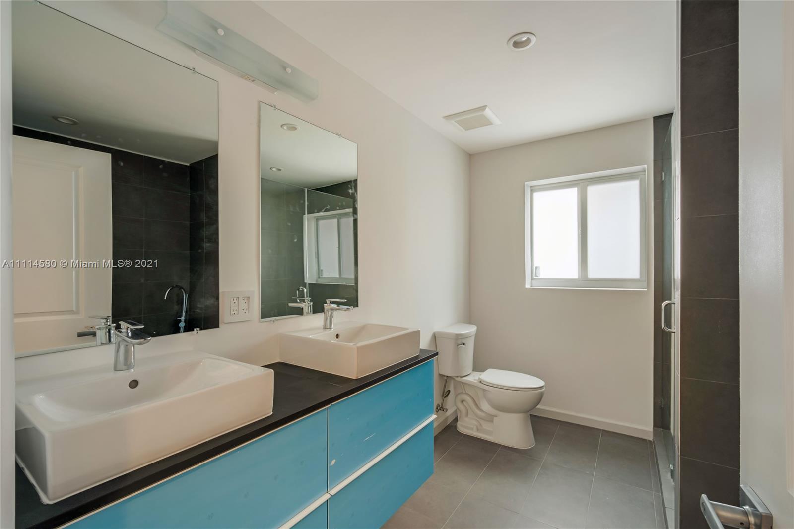 825 Southwest 28th Road Miami, FL 33129 - Photo 23 of 40 a bathroom with a double vanity sink mirror and toilet
