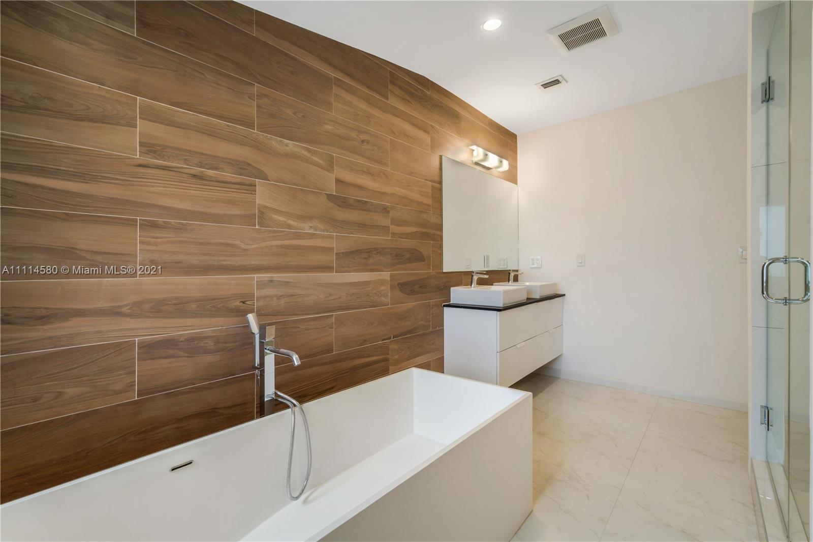 825 Southwest 28th Road Miami, FL 33129 - Photo 27 of 40 a bathroom with a bathtub and sink
