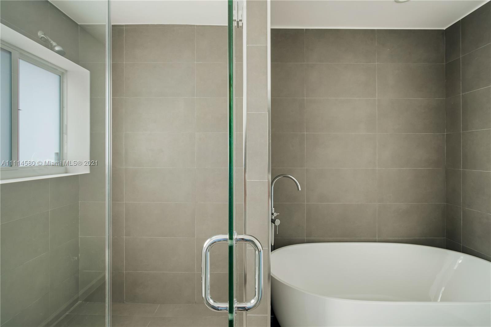 825 Southwest 28th Road Miami, FL 33129 - Photo 28 of 40 a white bath tub sitting next to a shower