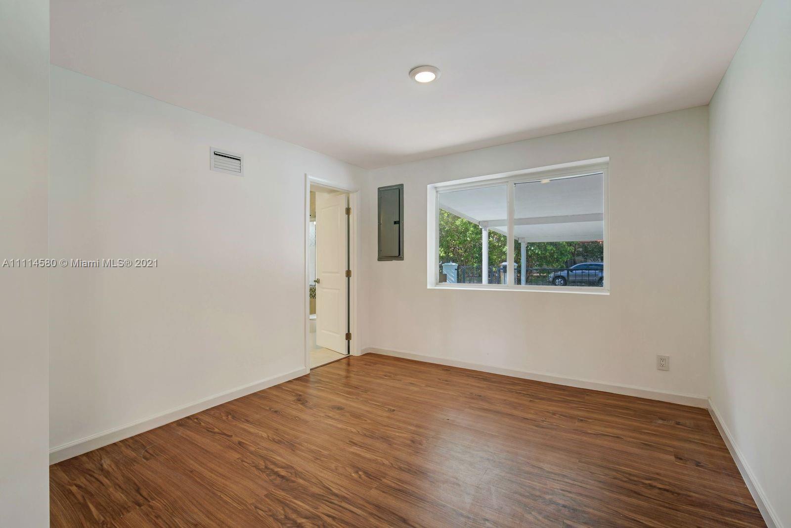 825 Southwest 28th Road Miami, FL 33129 - Photo 29 of 40 an empty room with wooden floor and windows