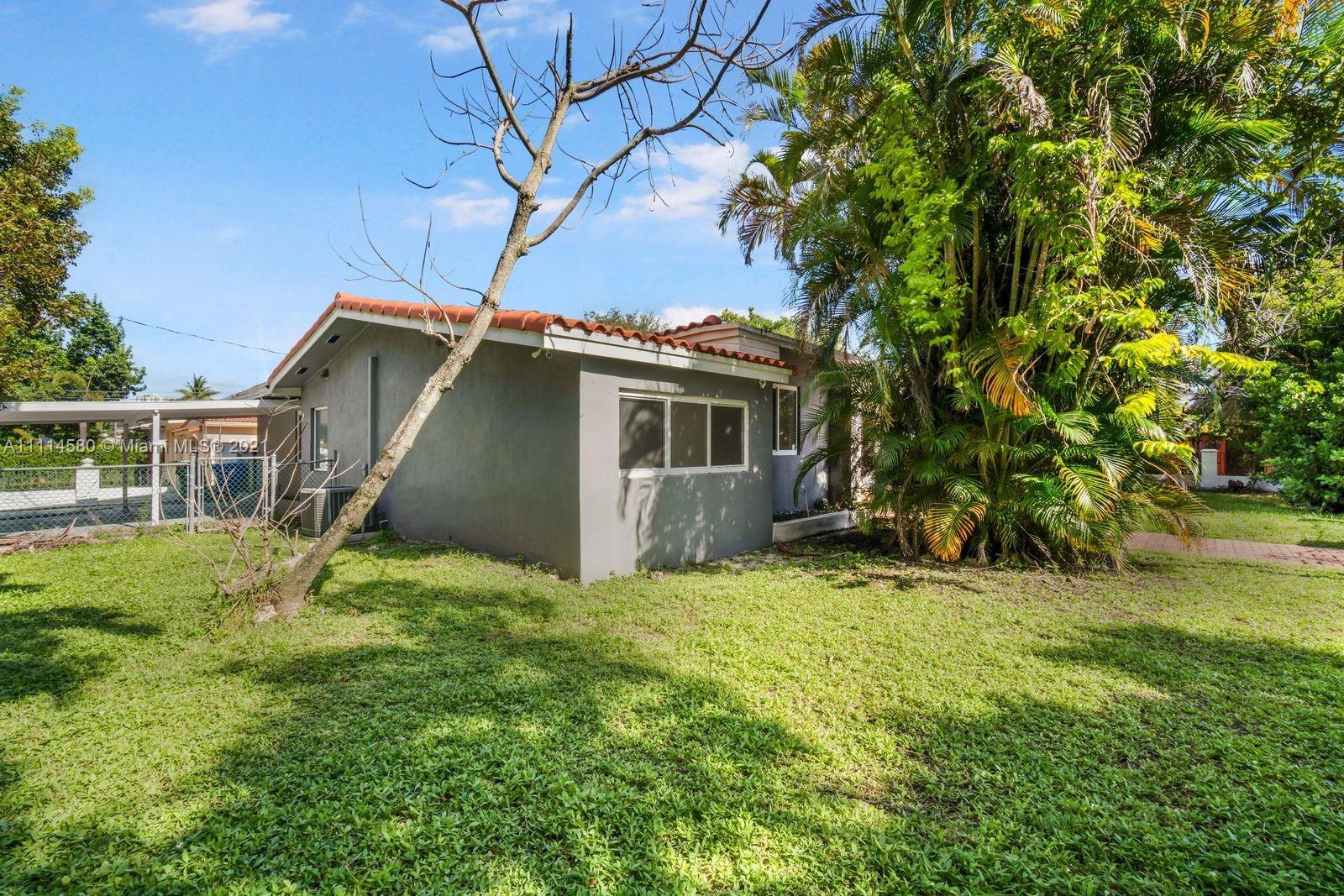 825 Southwest 28th Road Miami, FL 33129 - Photo 4 of 40 a view of front of house with a yard
