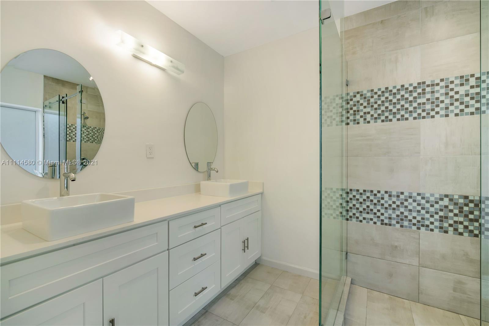 825 Southwest 28th Road Miami, FL 33129 - Photo 33 of 40 a bathroom with a double vanity sink mirror and double