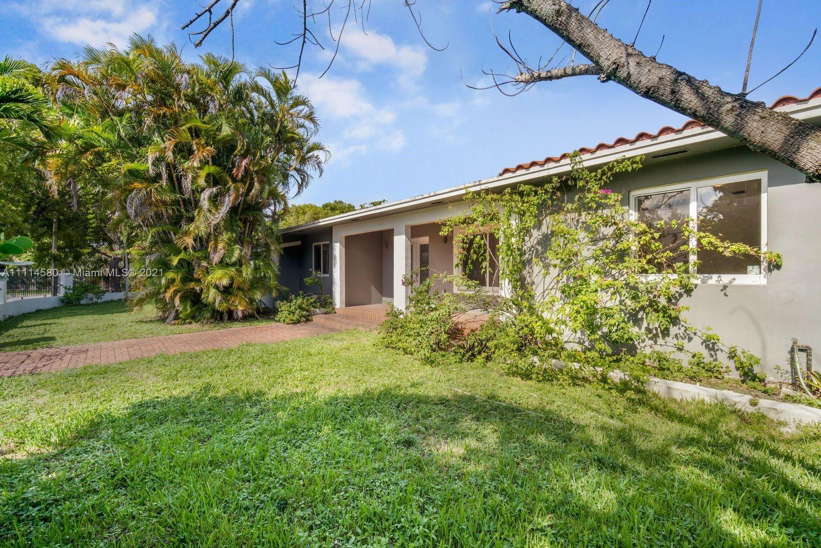 825 Southwest 28th Road Miami, FL 33129 - Photo 5 of 40 a view of a house with backyard and garden
