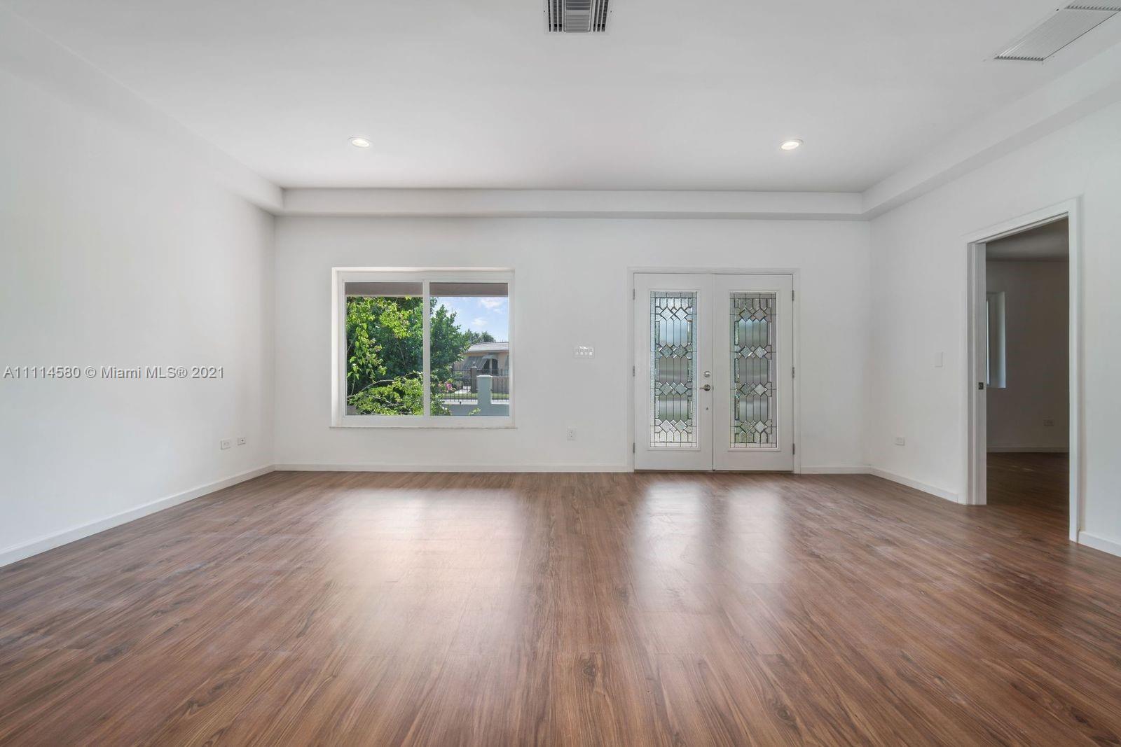 825 Southwest 28th Road Miami, FL 33129 - Photo 7 of 40 an empty room with wooden floor and windows